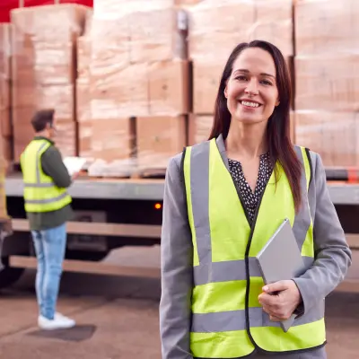 femme souriante responsable d'un camion de marchandises